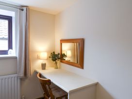 A home office with a desk and lamp at Owl in Pickering
