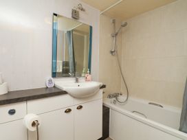 A bathroom with a sink, shower, and bathtub at Owl in Pickering