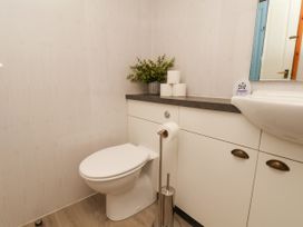 A bathroom with a toilet and sink at Owl in Pickering