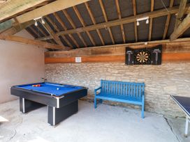 A games room with a pool table and a dartboard at Owl in Pickering