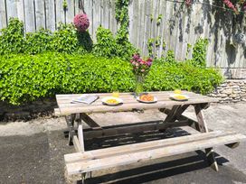 An outdoor dining area with a picnic table and plates at Owl in Pickering