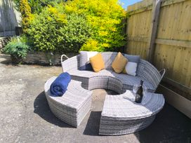 An outdoor seating area with sofa set and a champagne bottle at Owl in Pickering