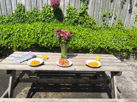 An outdoor dining area with a table set for breakfast at Owl in Pickering