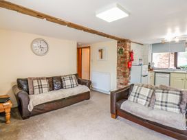 A living room with sofas and a clock at Owl in Pickering