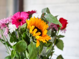 A bouquet of flowers including a sunflower and a rose at Owl in Pickering