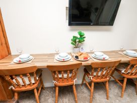 A dining room with a table and chairs at Owl in Pickering