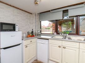 A kitchen with appliances and window view at Owl in Pickering