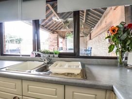 A kitchen with a sink and flower vase at Owl in Pickering