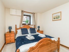 A bedroom with a bed and bedside tables at Owl in Pickering