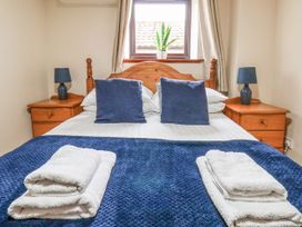 A bedroom with a double bed and bedside tables at Owl in Pickering