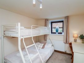 A bedroom with a bunk bed and desk at Owl in Pickering