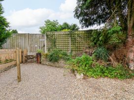 A garden area with a gravel path and a fence at Owl in Pickering