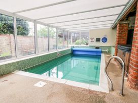 An indoor pool area with a swimming pool and spa at Owl in Pickering