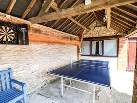 A games room with a dartboard and table tennis table at Owl in Pickering
