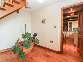 A hallway with a potted plant and staircase at Shepherd's Barn in Lancaster