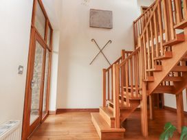 An entrance hall with a staircase and door at Shepherd's Barn in Lancaster