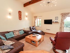 A living room with a sofa and coffee table at Shepherd's Barn Lancaster