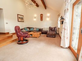 A living room with a sofa and coffee table at Shepherd's Barn Lancaster