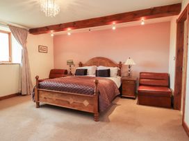 A bedroom with a bed and nightstand at Shepherd's Barn in Lancaster