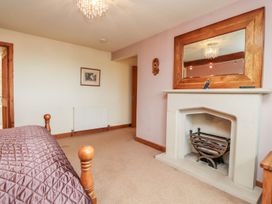 A bedroom with a bed and a fireplace at Shepherd's Barn in Lancaster