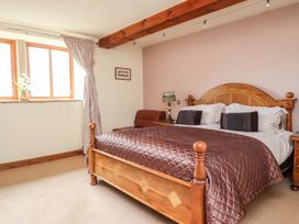 A bedroom with a bed and windows at Shepherd's Barn in Lancaster