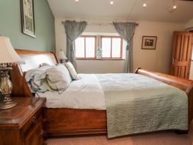 A bedroom with a bed and a window at Shepherd's Barn in Lancaster