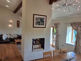 A living room with a fireplace and dining area at Shepherd's Barn in Lancaster