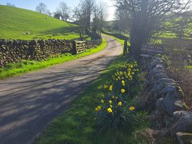 A road with a gate and sign at Shepherd's Barn in Lancaster