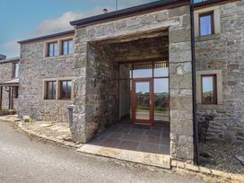 An entrance with stone walls and a wooden door at Shepherd's Barn in Lancaster