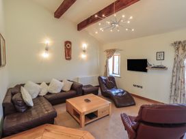 A living room with a sofa and television at Shepherd's Barn in Lancaster