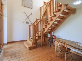 An entryway with a wooden staircase and table at Shepherd's Barn in Lancaster