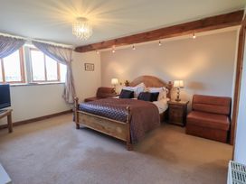 A bedroom with a bed and side tables at Shepherd's Barn in Lancaster