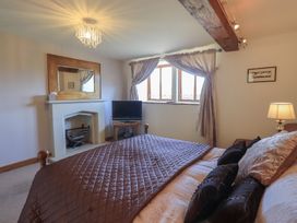 A bedroom with a bed and television at Shepherd's Barn in Lancaster