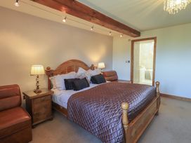 A bedroom with a bed and nightstand at Shepherd's Barn in Lancaster