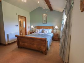 A bedroom with a bed and nightstand at Shepherd's Barn in Lancaster
