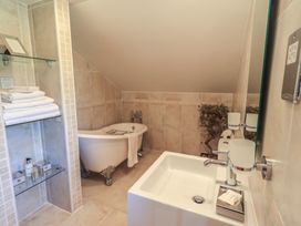 A bathroom with a bathtub and sink at Shepherd's Barn Lancaster