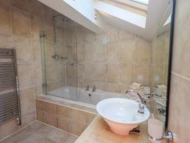 A bathroom with a bathtub and sink at Shepherd's Barn in Lancaster