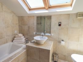 A bathroom with a bathtub and sink at Shepherd's Barn in Lancaster