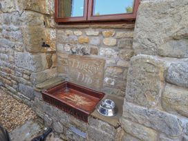 An outdoor dog wash station with a stone wall at Shepherd's Barn in Lancaster