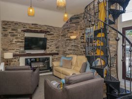A living room with a sofa and a television at Hillside Cottage in Bowness-On-Windermere