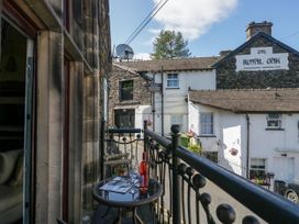 A balcony with a table and glass in front of The Royal Oak in Bowness-On-Windermere