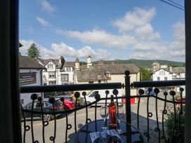 A balcony view with a table and glasses at Hillside Cottage in Bowness-On-Windermere