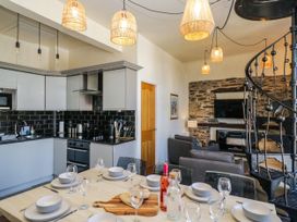 A kitchen with a dining table set at Hillside Cottage in Bowness-On-Windermere