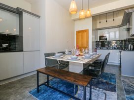 A dining room with a table set for a meal at Hillside Cottage in Bowness-On-Windermere