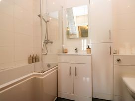 A bathroom with a bathtub and shower at Hillside Cottage in Bowness-On-Windermere