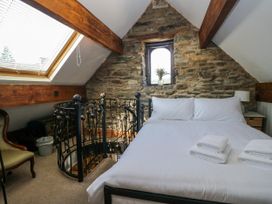 A bedroom with a bed and a window at Hillside Cottage Bowness-On-Windermere