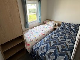 A bedroom with two beds and a window at Trecco bay holiday park- Magnolia 11 Porthcawl
