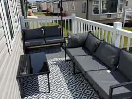 A seating area with a sofa and coffee table at Trecco bay holiday park- Magnolia 11 Porthcawl