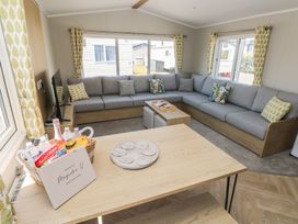 A living room with a sofa and coffee table at Trecco Bay Holiday Park - Magnolia 11 Porthcawl