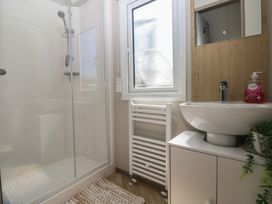 A bathroom with a shower and sink at Trecco Bay Holiday Park - Magnolia 11 Porthcawl